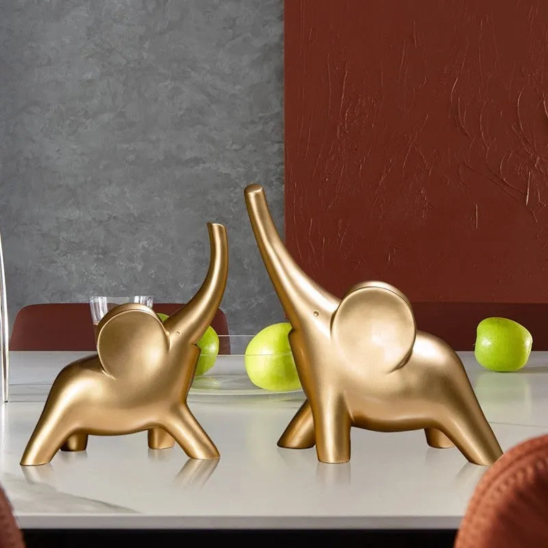Rose gold and white resin elephant ornaments in large and small sizes displayed singly and as pairs