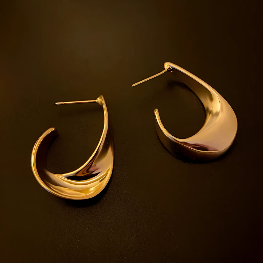 Pair of twisted geometric design metal earrings in gold or silver electroplated finish