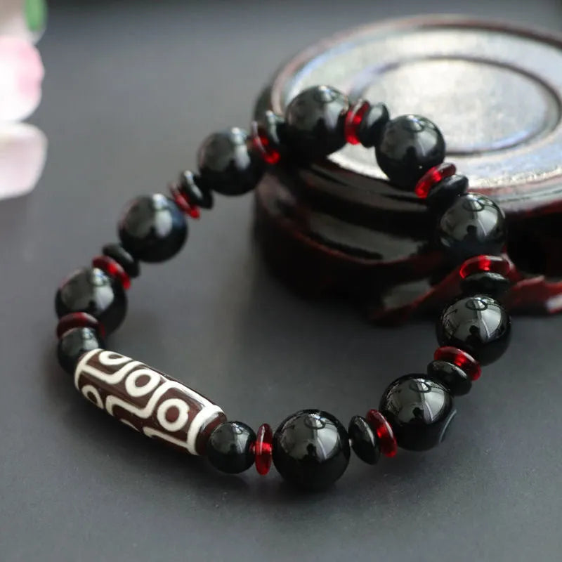 Black agate dzi bead bracelet with hand-woven construction and 11mm geometry beads