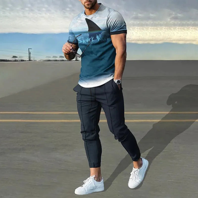 Men's grey printed short-sleeved tracksuit top and trousers laid flat.