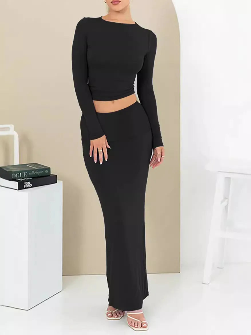 Women's black slim fit polyester two-piece suit with three-quarter sleeves and a long skirt.