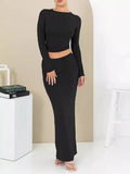 Women's black slim fit polyester two-piece suit with three-quarter sleeves and a long skirt.