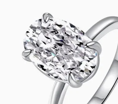 Oval silver ring with four-claw setting displaying hand-cut gemstone centrepiece