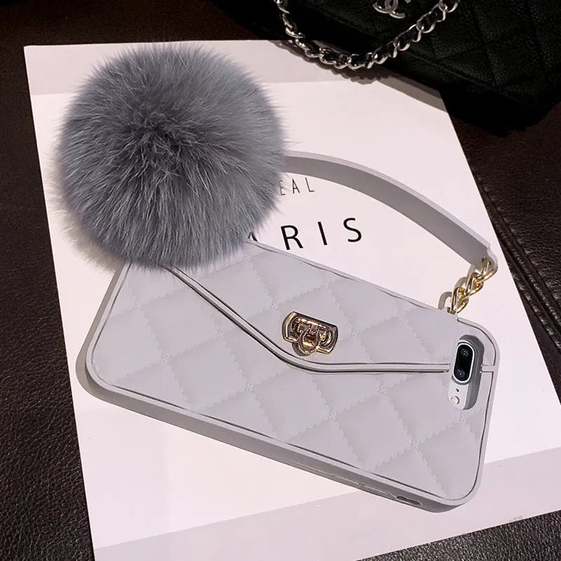 Plush textured hairball iPhone back cover case in a dark green grid pattern, showing the tactile surface.