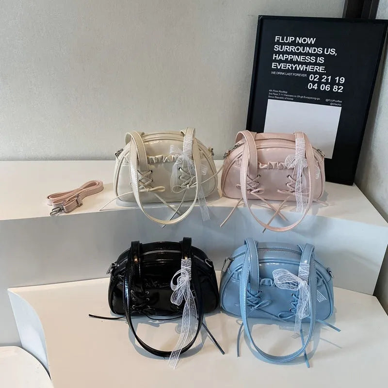 Women's white PU leather shoulder bag with a large bandage bow detail on the front.