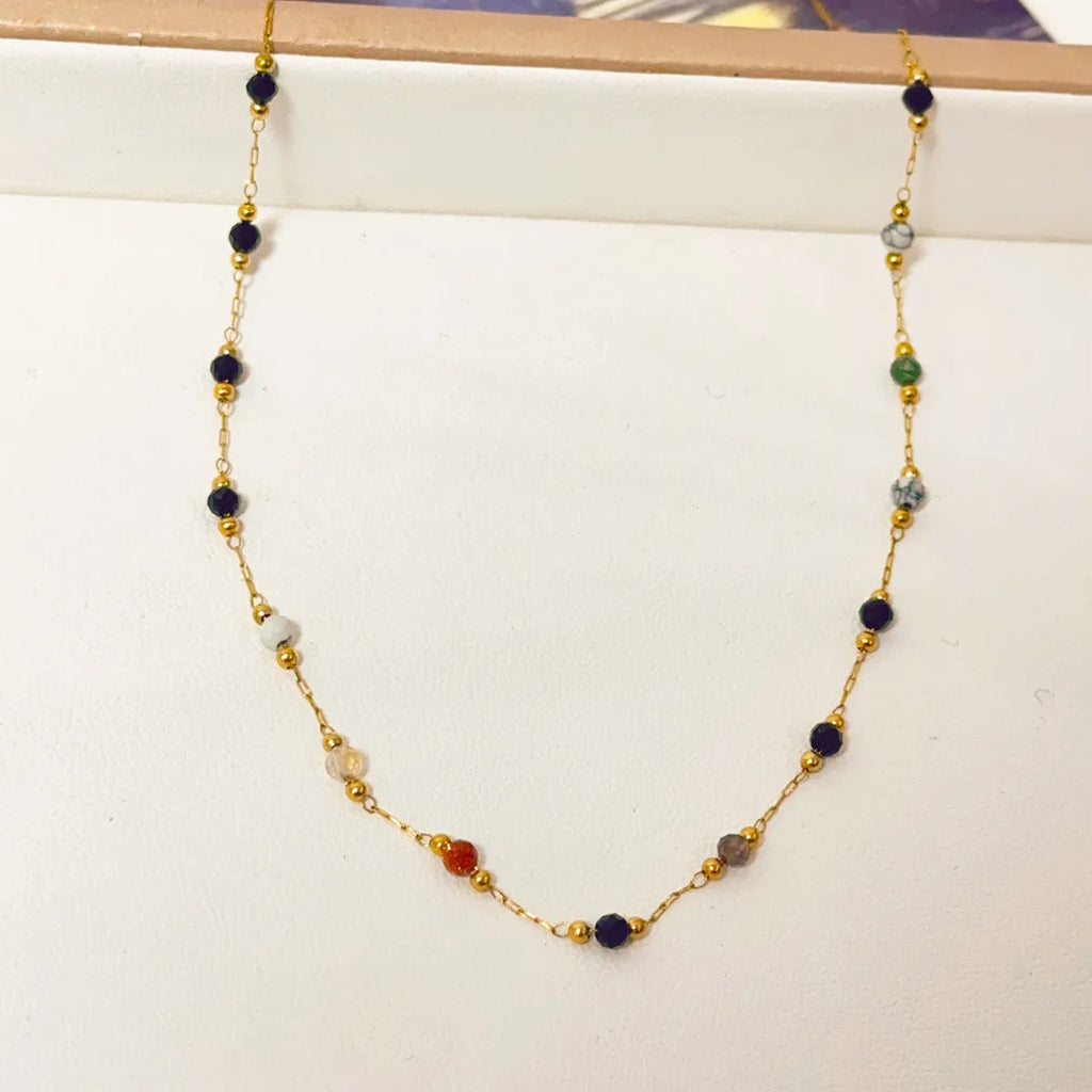 Gold electroplated titanium steel necklace with a natural stone pendant on an O-ring chain.
