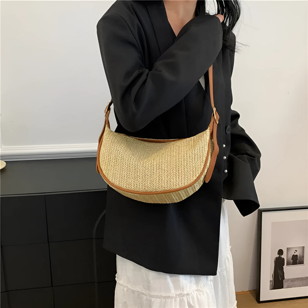 Women's woven straw crossbody bag showing internal phone and document compartments