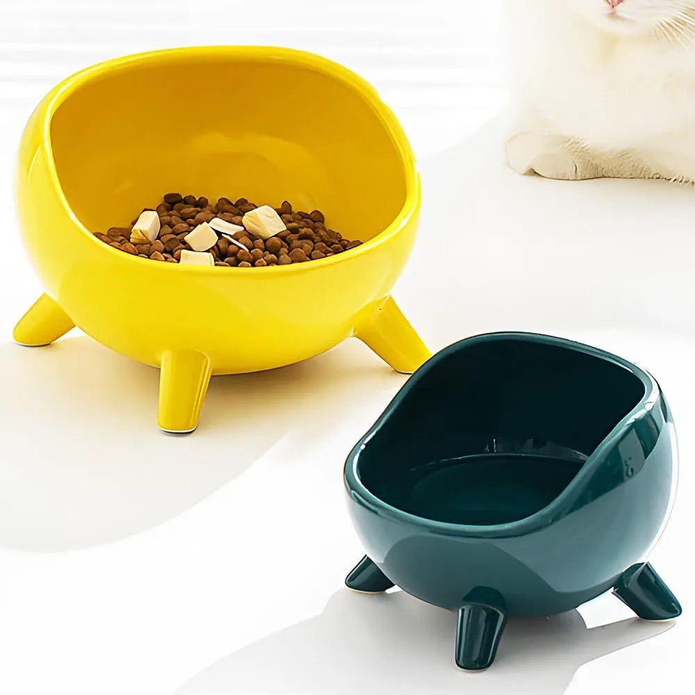 Green ceramic pet food bowl with four legs and a wide, rounded opening.