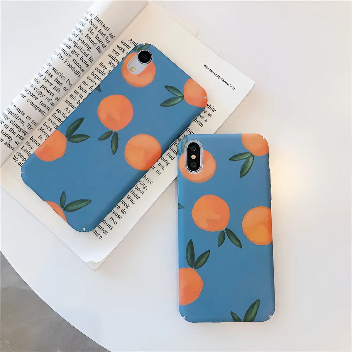 Orange retro plastic back cover phone case for iPhone on a blue and water background.