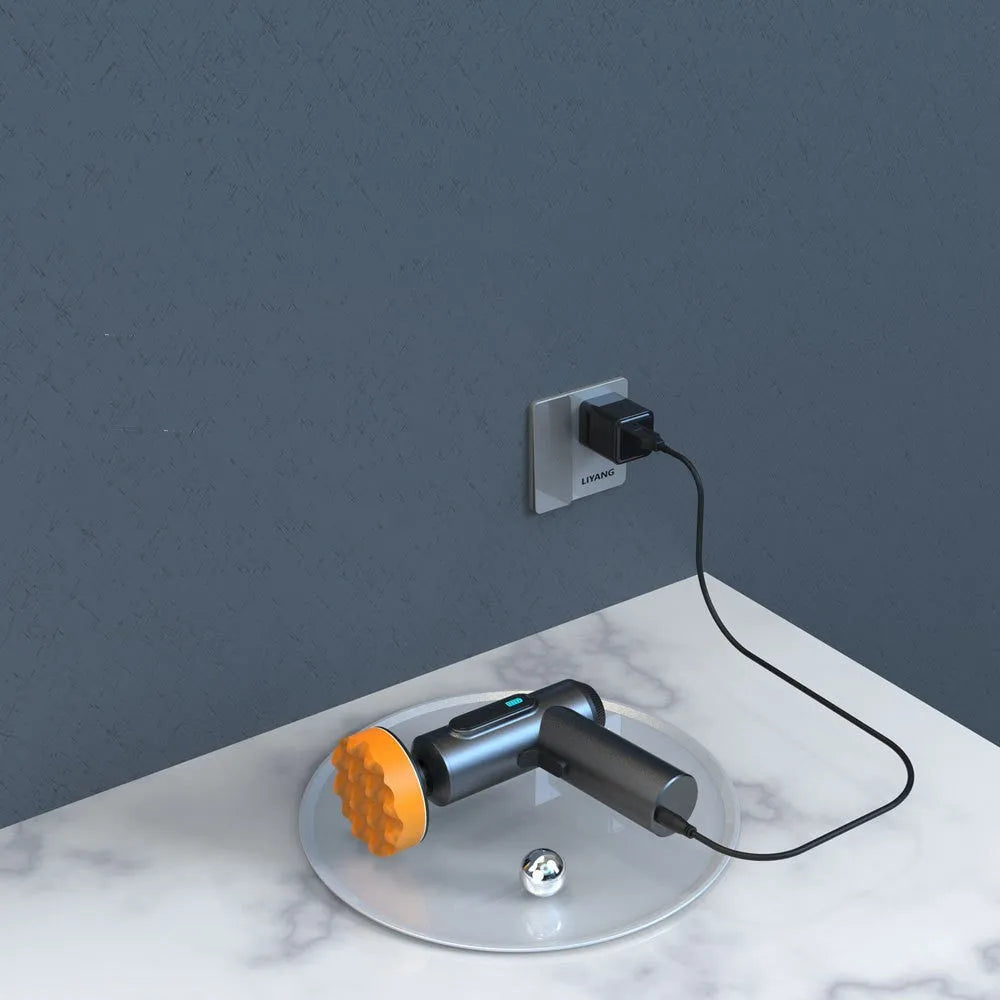 Cordless electric waxing and polishing machine with orange housing on a wooden floor