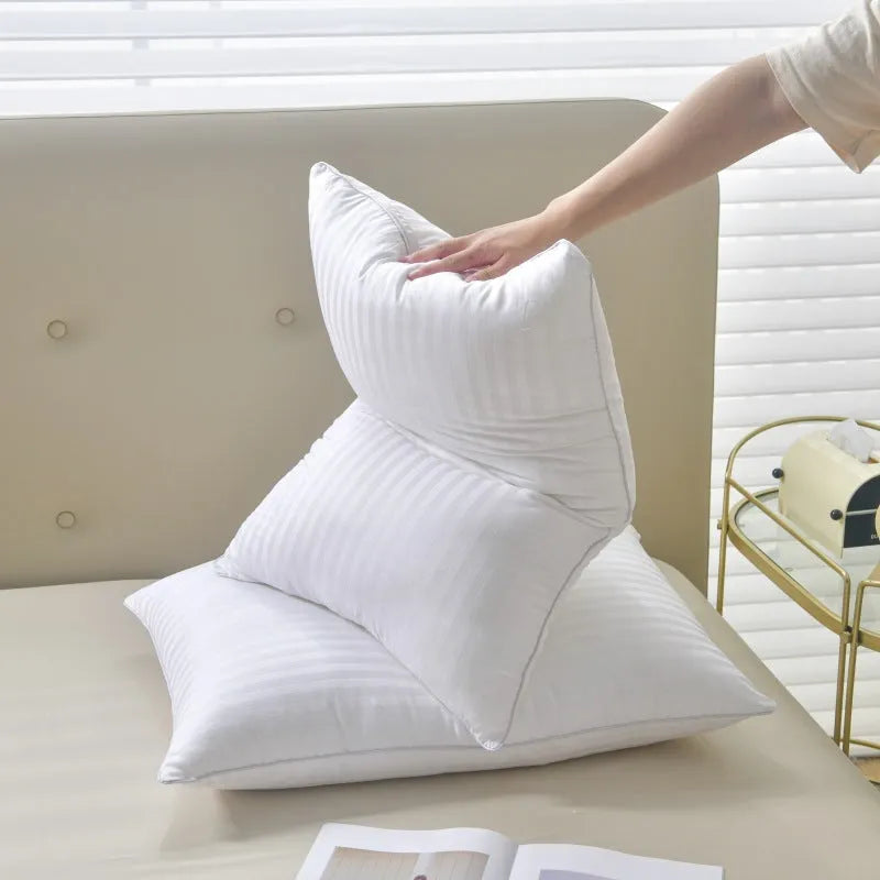 White cotton satin stripe feather and cotton pillow showing three size options