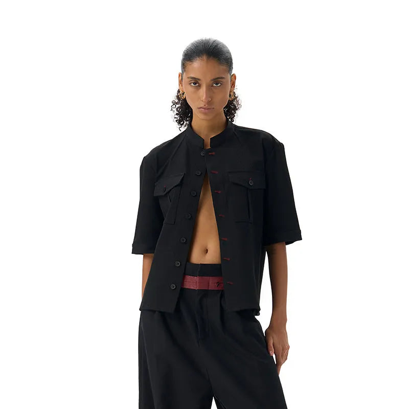 Handmade black loose fit half sleeve button-down shirt for men, shown on a hanger.