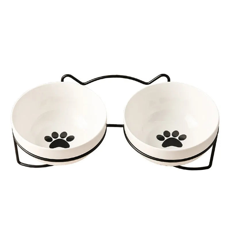 White ceramic cat bowl with cat paw design in black iron frame