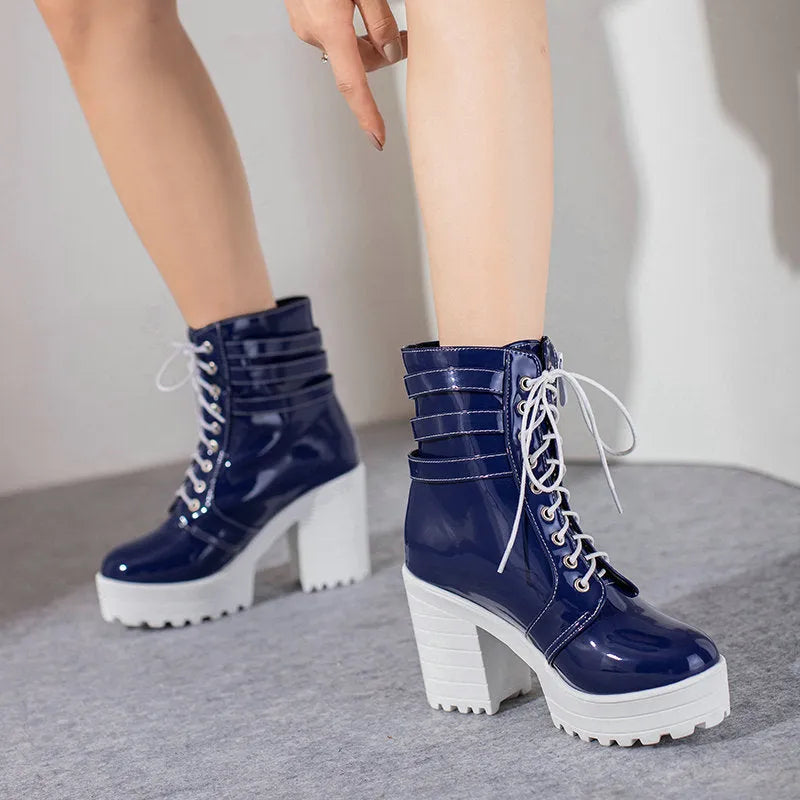 Women's black chunky heel ankle boots with front lace-up and round toe on a waterproof rubber sole.