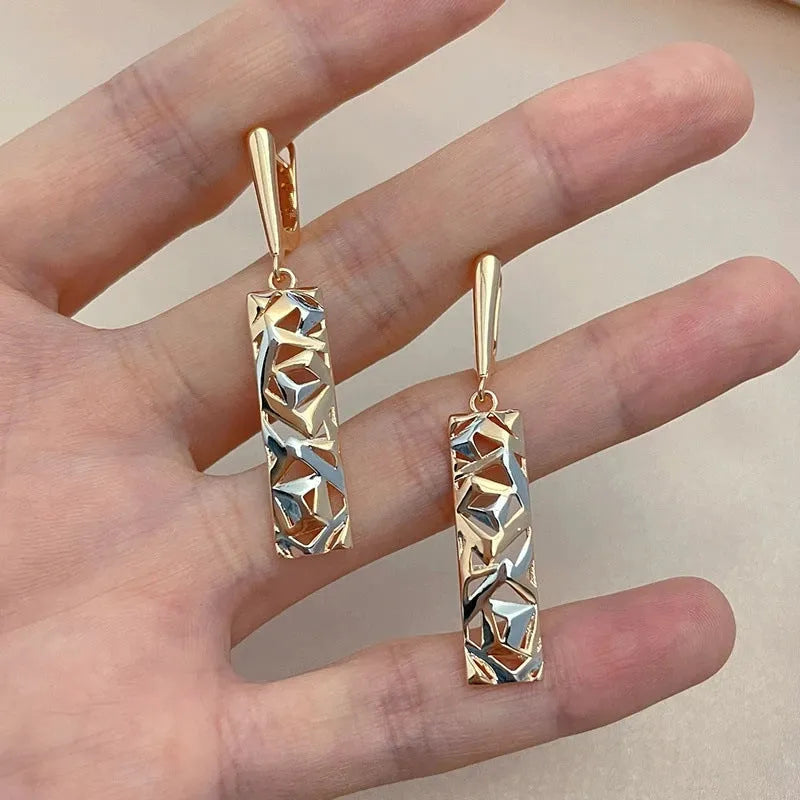 A pair of rectangular hollow stud earrings with a two-tone electroplated finish on a white background.