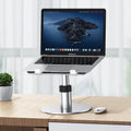 Silver aluminium car laptop stand with adjustable height and 360-degree rotating base on a car seat.