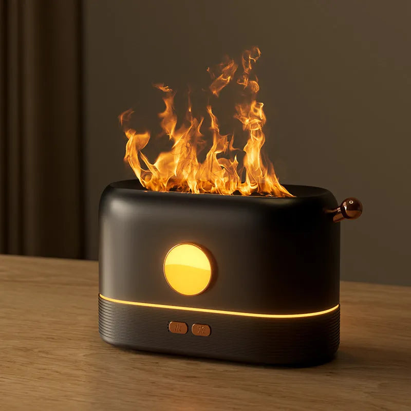 Black USB-powered humidifier with simulated orange flame effect and mist on a wooden desk.