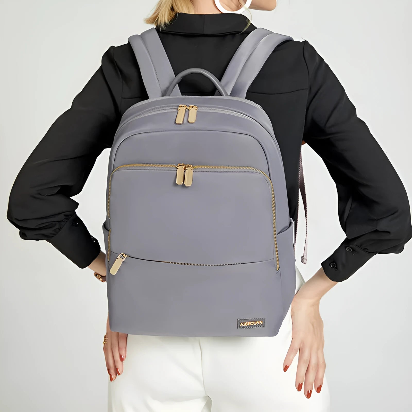 Large capacity Oxford cloth women's backpack in black and purplish grey, showing anti-theft and waterproof features.