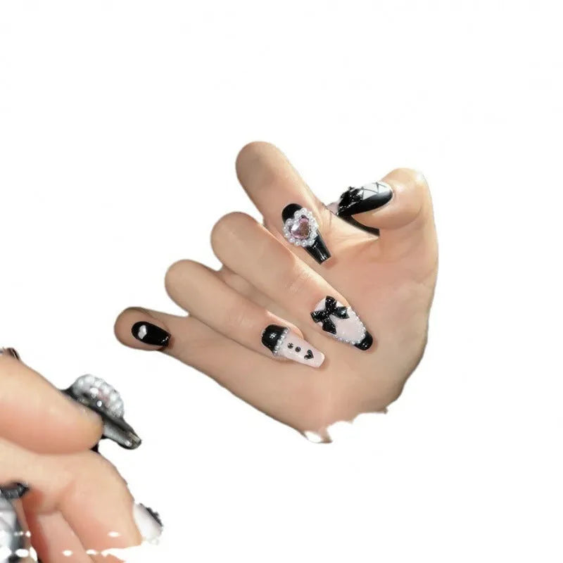Black and pink peach heart hand-painted press on nails with bow detailing in cat eye gel style