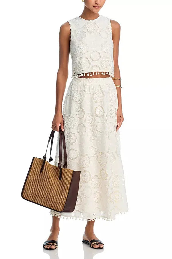 White women's retro style suit set with sleeveless top and embroidered long skirt on hanger