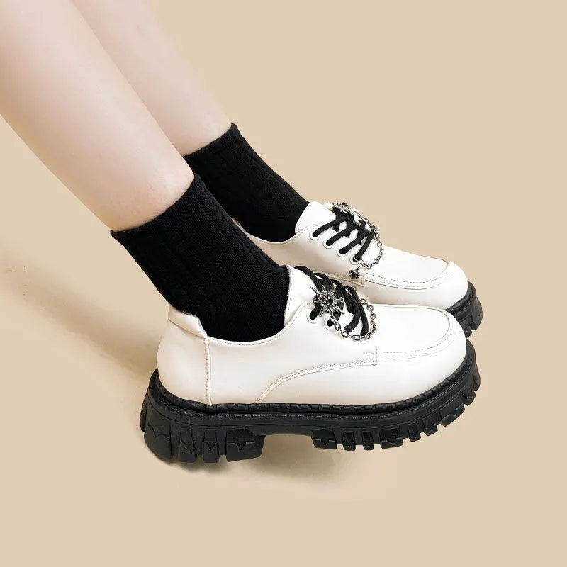 Women's preppy style loafers in Duke Asterism colour with metal cross shoulder strap and round toe
