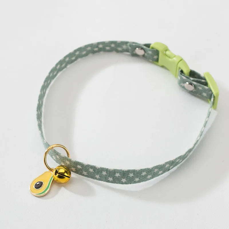 Green adjustable cat collar with a silver bell and a matching bow tie on a white background