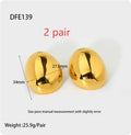 A pair of geometric stainless steel ear studs with a linear design and a glazed gold-coloured surface.