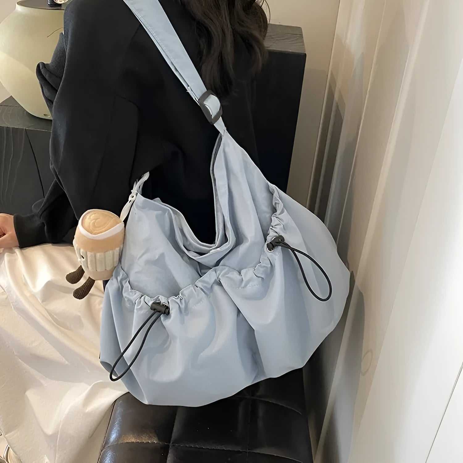 Green pleated foldable polyester crossbody bag showing split pocket and internal phone compartment.