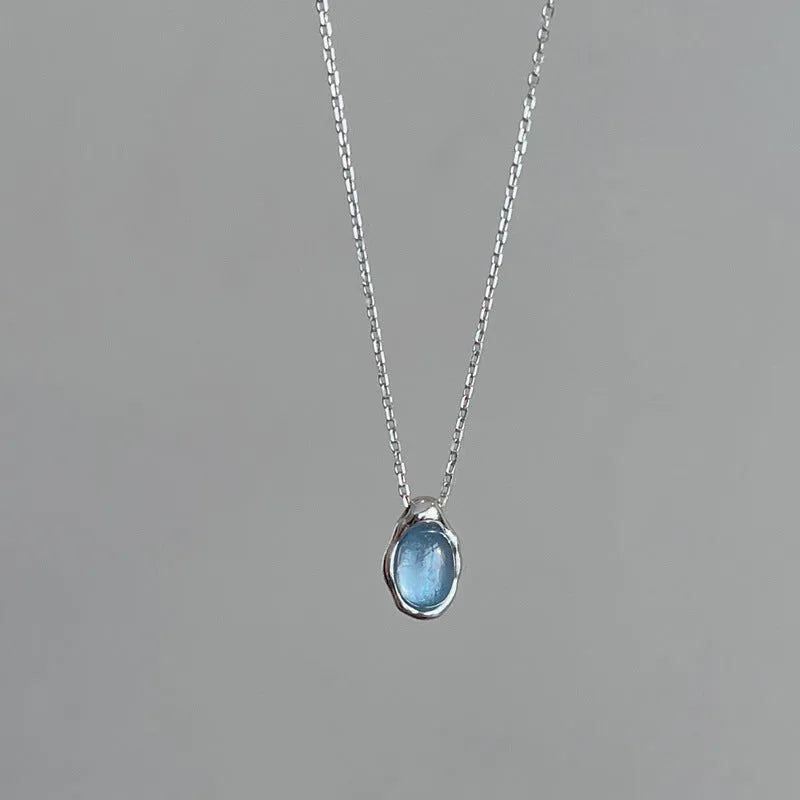 Navy blue water drop necklace with geometric pendant on cross chain, adjustable length jewellery