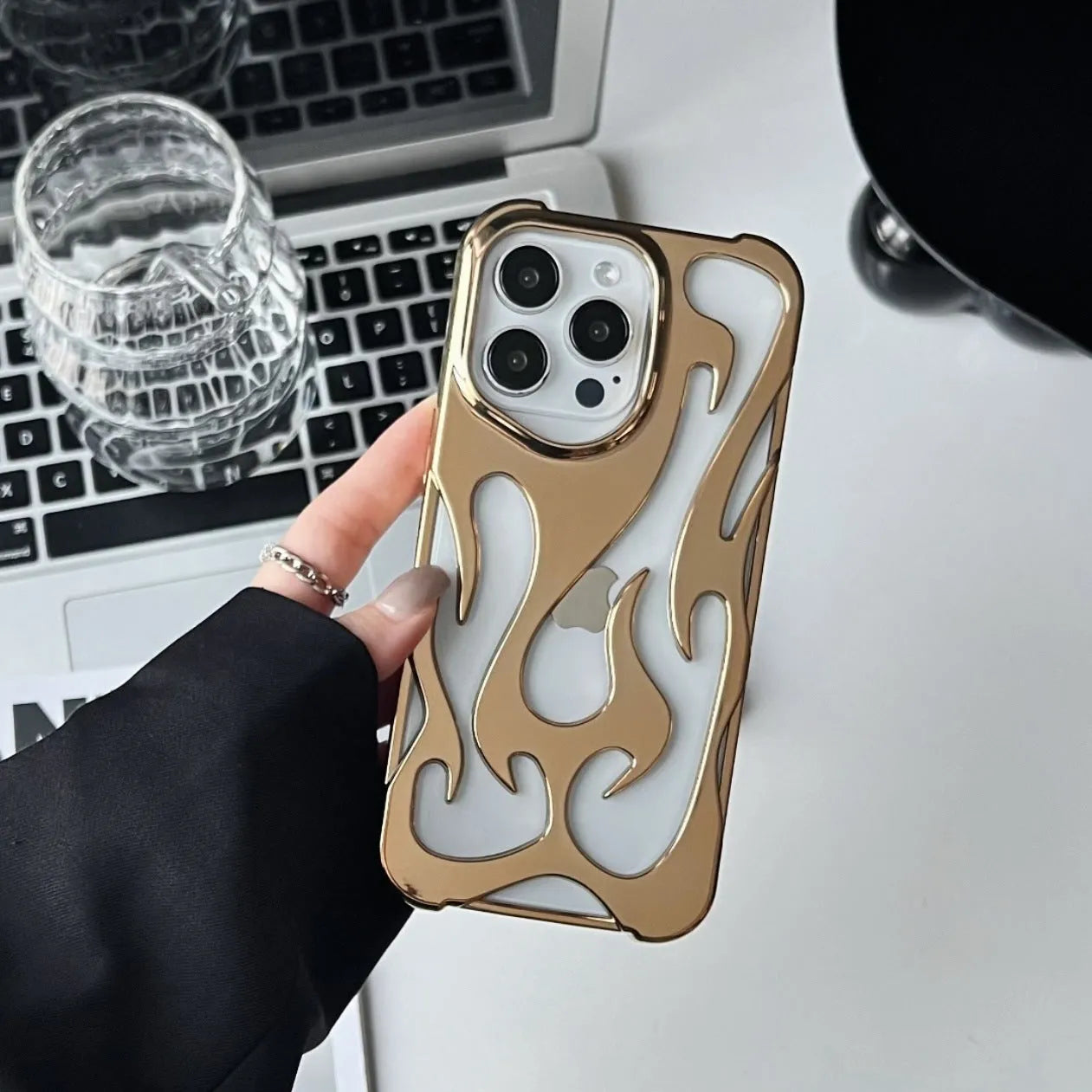 Electroplated iPhone case with hollow flame pattern design in gold, black, purple, and silver finishes