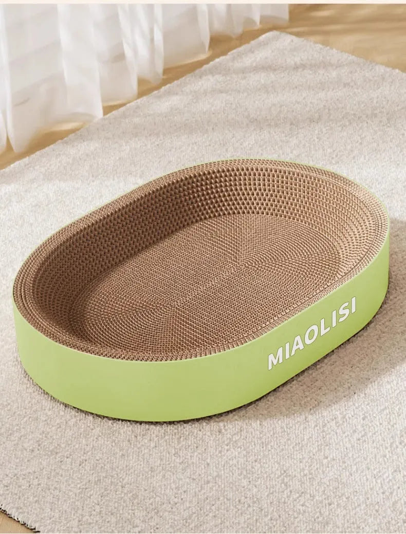 Green oval corrugated paper cat nest with scratch board surface measuring 55 cm diameter