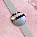 Circular smartwatch for women with metal strap and colour touchscreen on a wrist.