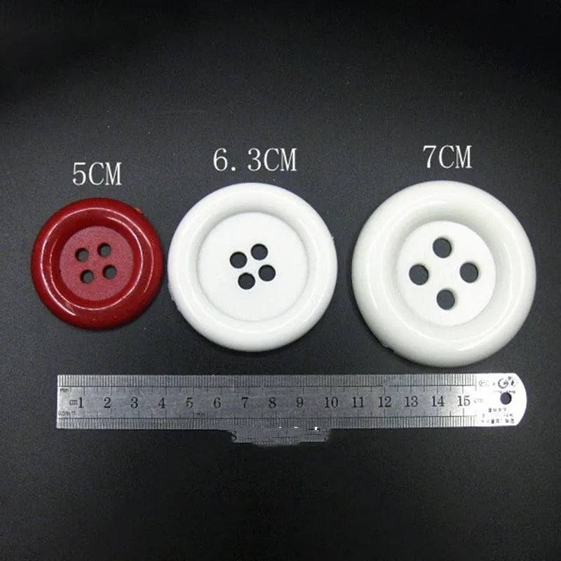 Assortment of oversized round plastic buttons in multiple colours showing four-hole design