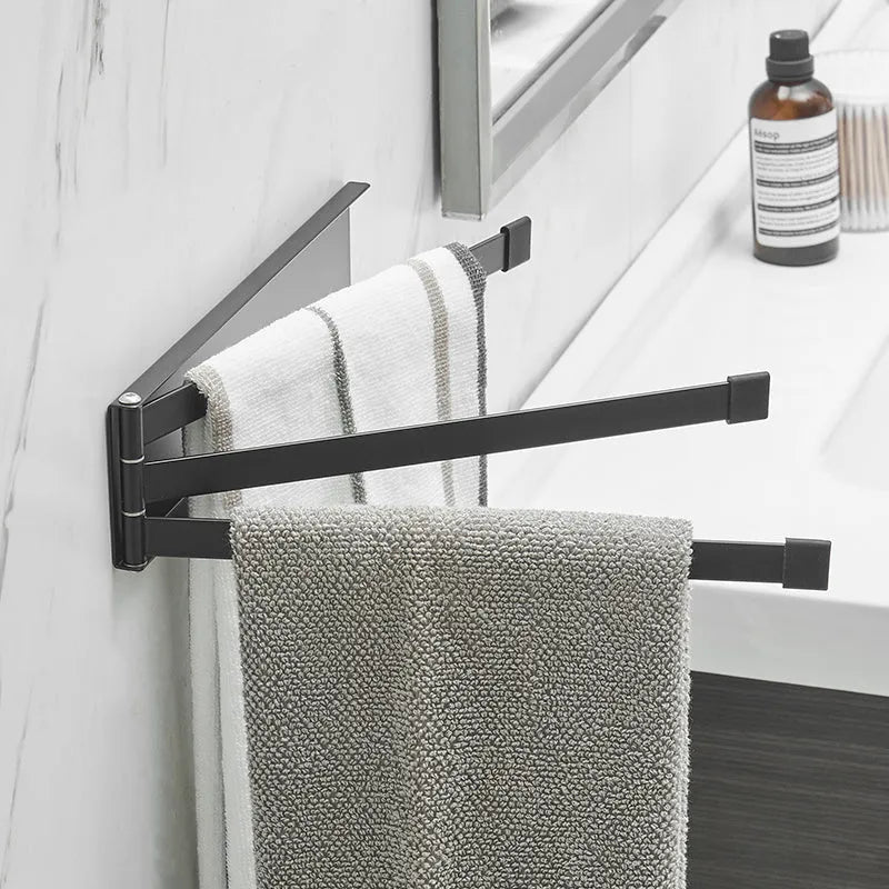 Nordic style black folding towel rack mounted on a white bathroom tile wall.