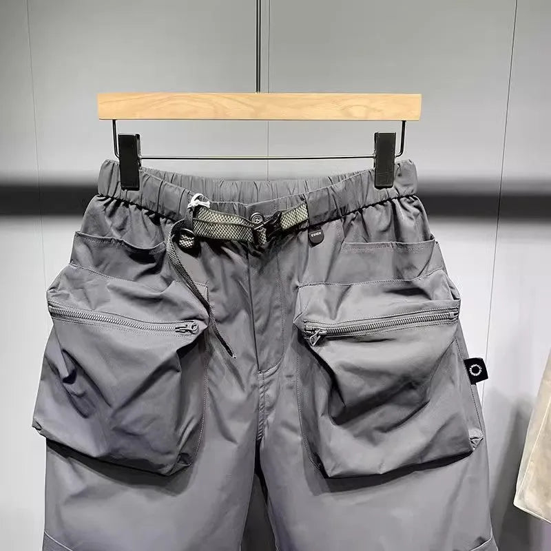 Men's loose fit black casual shorts with pockets and straight leg hem.