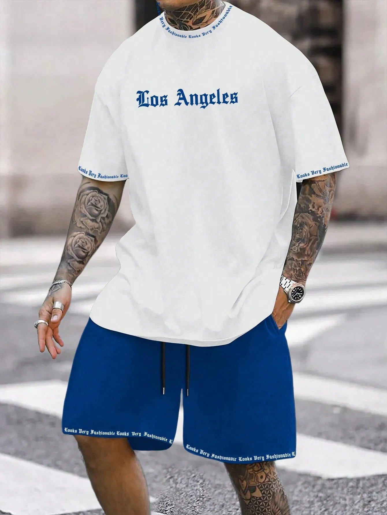 Man wearing a grey short-sleeve top and matching shorts from a sports co-ord set.