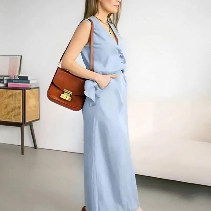 White sleeveless vest and long maxi skirt two-piece casual suit on a hanger.