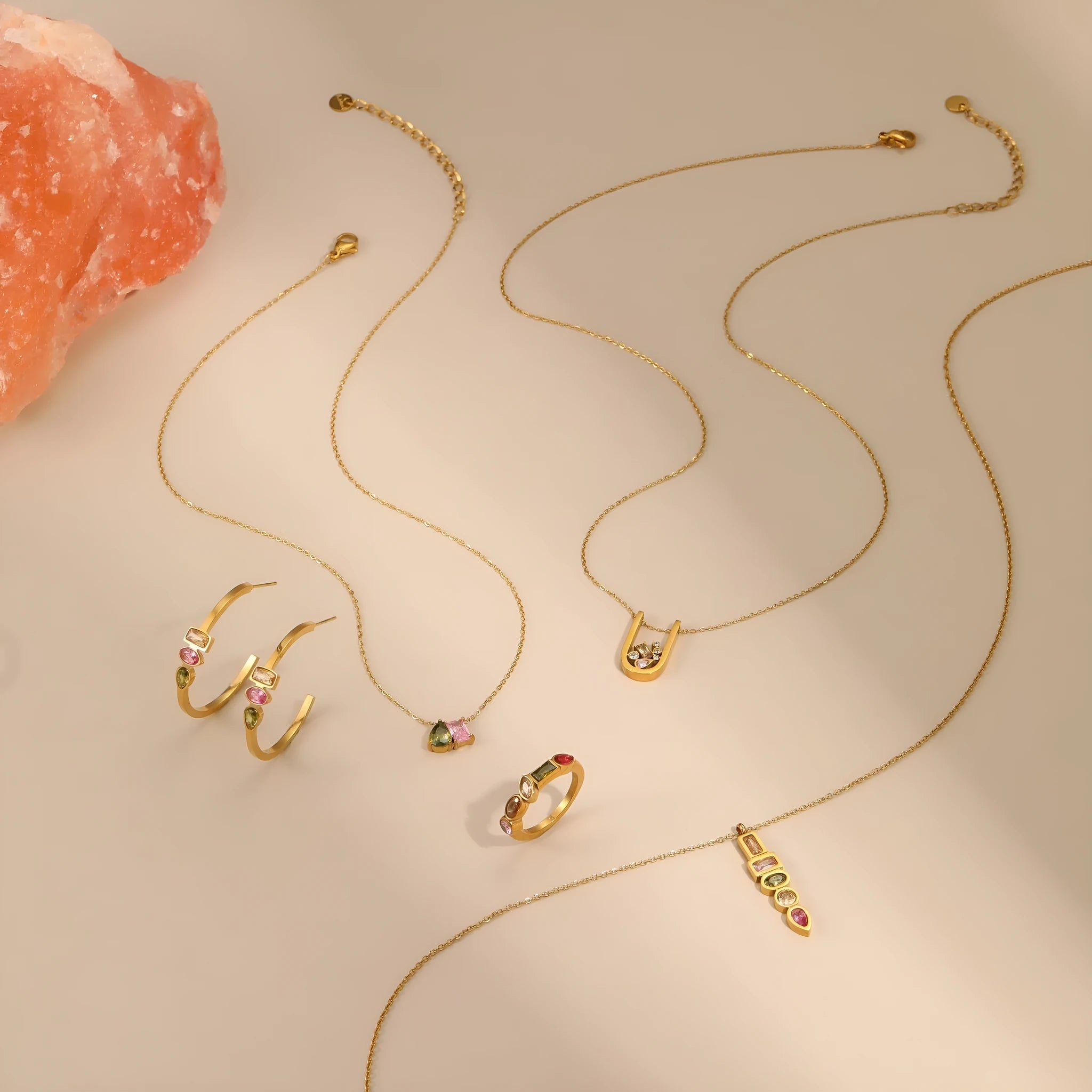 Geometric gold-plated zircon jewellery set showing necklace, ring and earrings with adjustable chain
