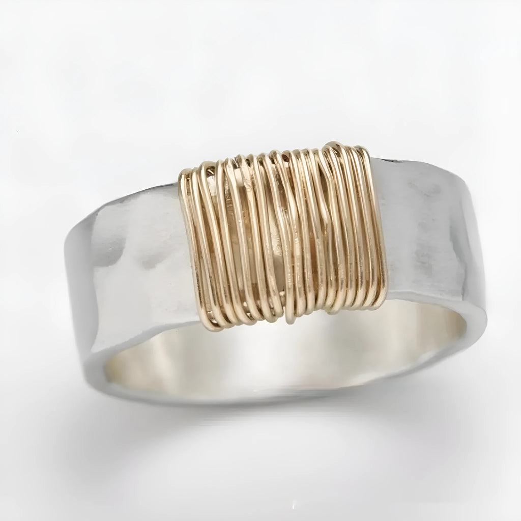 Geometric copper bracelet with irregular coil design and silver-gold electroplated finish.