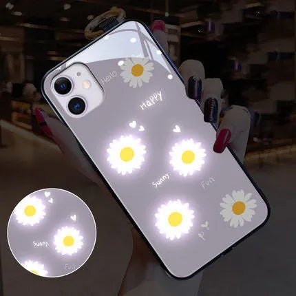 Luminous iPhone case with voice-activated colour light showing white daisy pattern on TPU protective shell
