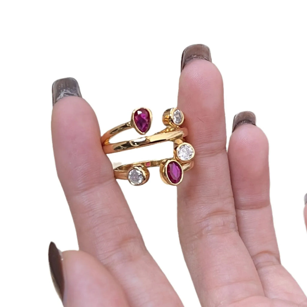 Double-headed irregular geometric cross ring in two-tone colours on a copper band.