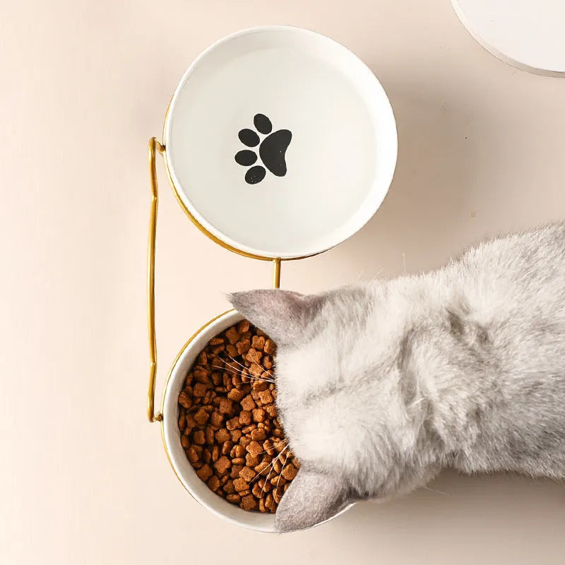 White ceramic cat bowl with cat paw design in black iron frame