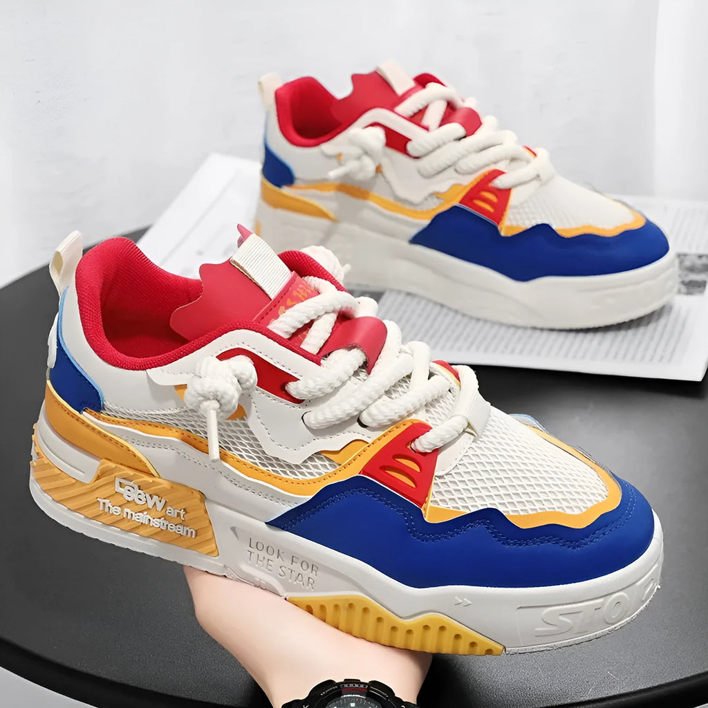 Men's white and yellow low-top board shoes with a rubber sole on a plain background.