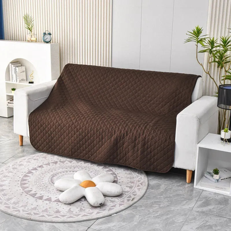 Reversible waterproof dog blanket on sofa showing two colour options with multiple size measurements