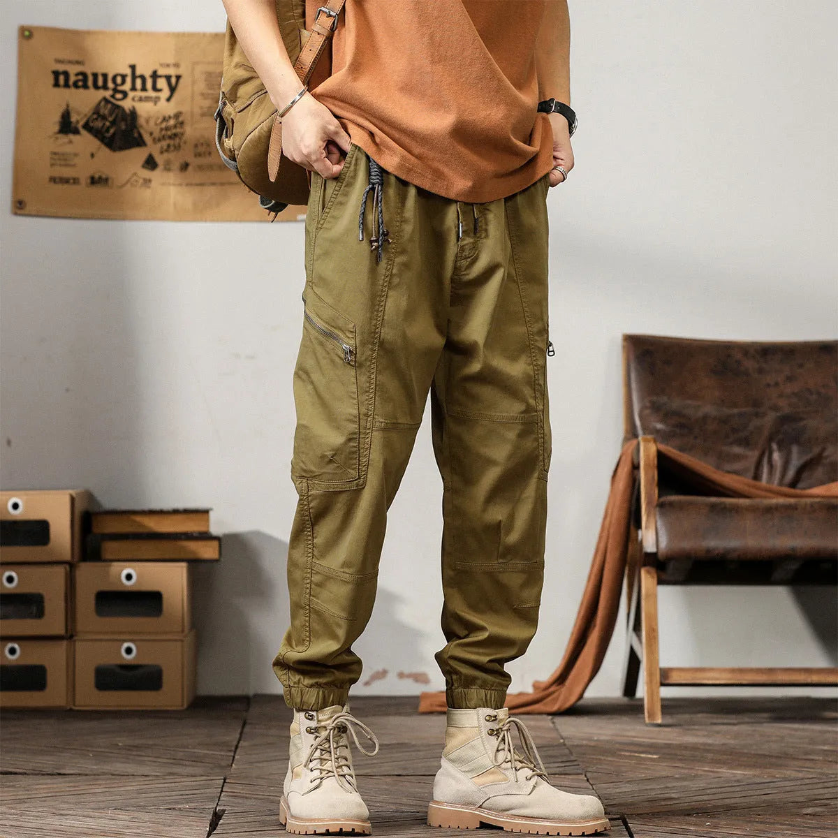 Men's khaki coloured loose-fit tapered harem pants with a small ankle band and elasticated waist.