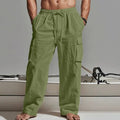 Man wearing loose-fit khaki cotton casual trousers with a wide-leg cut and elasticated waist.