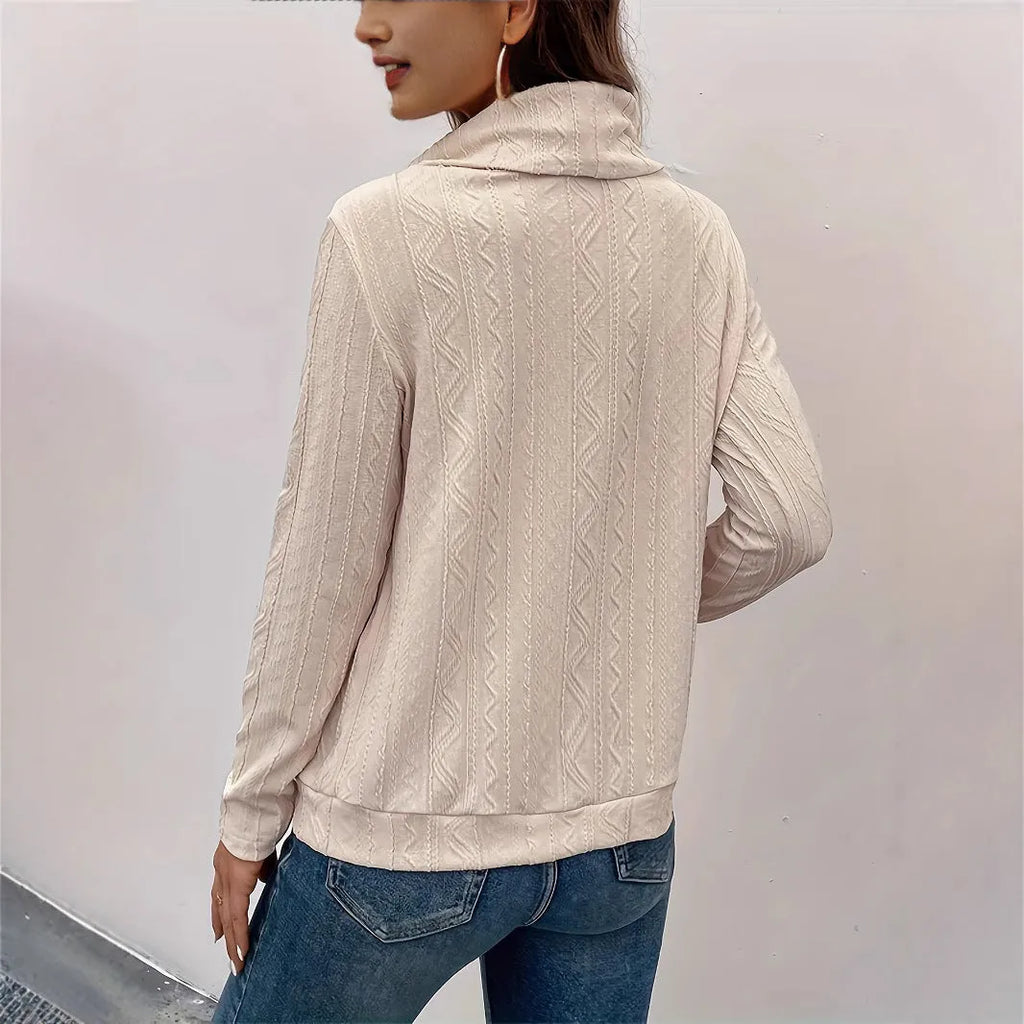 Apricot coloured long sleeve hooded pullover sweater with a drawstring hood on a hanger.