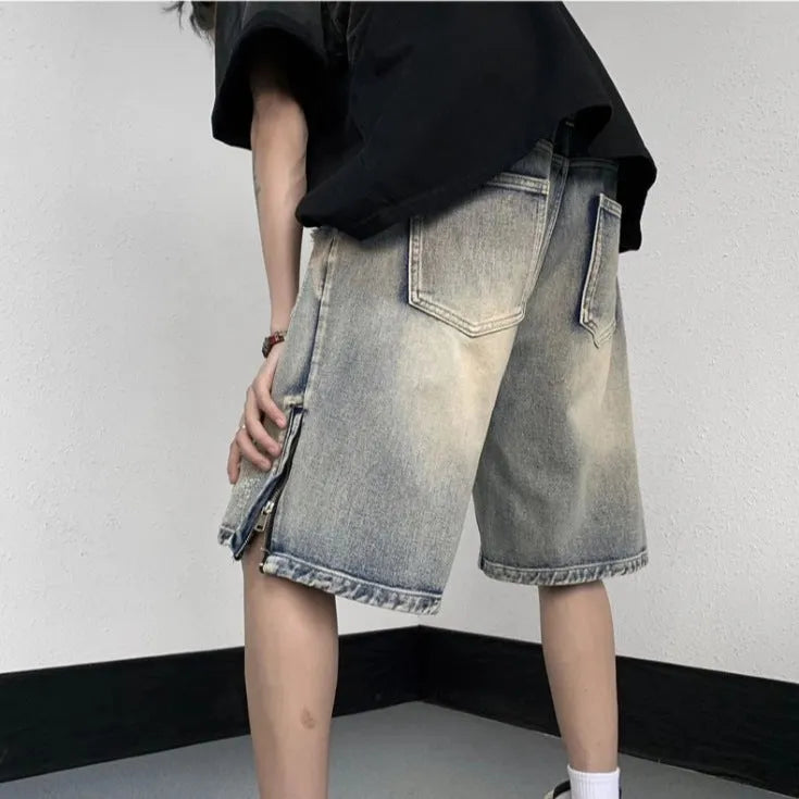 Blue retro-style denim shorts with a wide-leg loose fit and tattered detailing on a model.