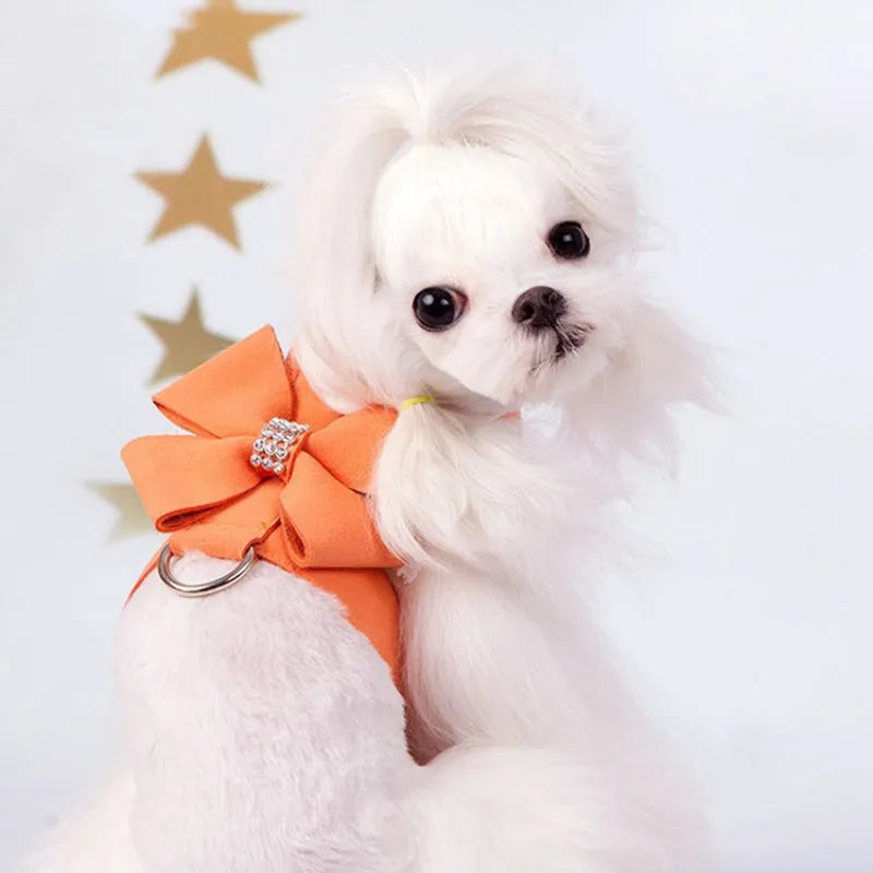 A pink microfiber dog chest strap featuring a sewn-on bowknot shaped like a puppy.