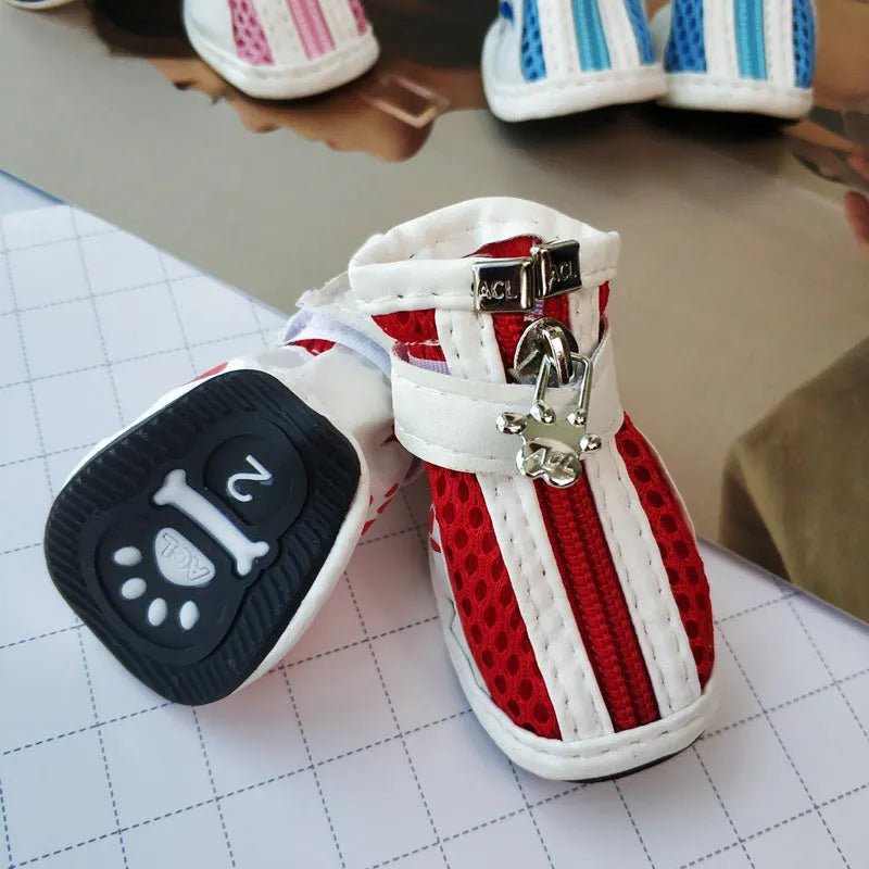 Set of four blue cloth dog shoes for small dogs with non-slip soles and a zip fastening.